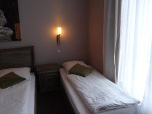 Postel nebo postele na pokoji v ubytování Hotel Commodore