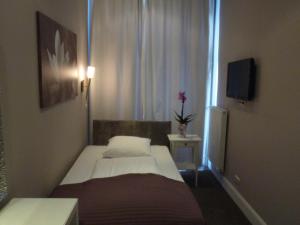 Postel nebo postele na pokoji v ubytování Hotel Commodore