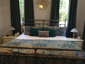 a bedroom with a large bed with blue pillows at The Ocean Bay House in Bay Shore