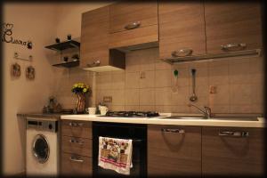 a kitchen with a sink and a stove top oven at Casa Vacanze Cayohouse in Messina