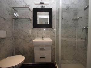 a bathroom with a toilet and a sink and a shower at Villa Sirene Whg 12 Meerblick - 5 Sterne in Binz +36 photos