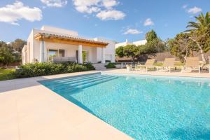 a swimming pool in front of a villa at Villa Menorca 16 in Cala d´Or