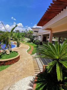 a house with a walkway next to a swimming pool at Camotes Ocean Heaven Resort in Camotes Islands