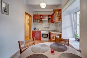 a small kitchen with a table and two chairs and a table and a table at Vidos apartamentai 2 in Vilnius