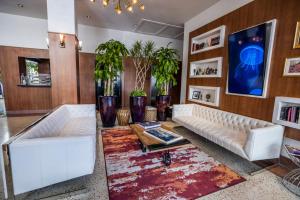 
a living room filled with furniture and decor at Hotel Croydon in Miami Beach
