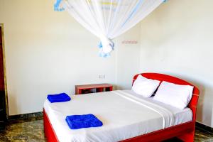 a bedroom with a bed and a dresser at Will Guest Homestay in Ella