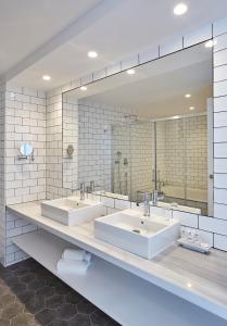 a bathroom with three sinks and a large mirror at Gran Hotel Flamingo-Adults Only older 18 years old in Lloret de Mar