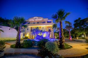 ein Hotel mit Palmen vor einem Gebäude in der Unterkunft Elia Hotel in Buccino