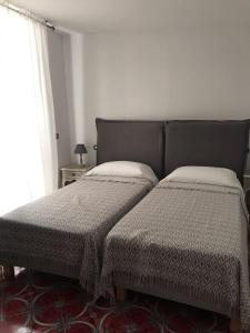 A bed or beds in a room at R&D Rest and Dream Capri