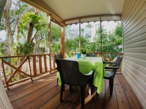 a table on a deck with a table and chairs at Casa Ingrid in San Andrés