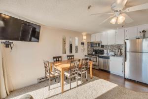 a kitchen and dining room with a table and chairs at Stroll to Slopes, Village Area, Ski in-out MtLodge 333 in Snowshoe