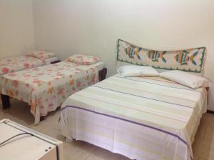Tempat tidur dalam kamar di Pousada Vila Verde