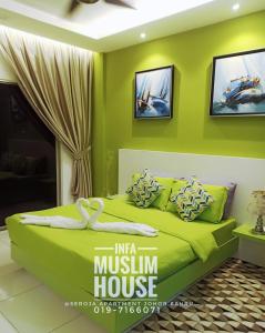 a green bedroom with a bed in a room at INFA - Muslim House @ Seroja Apartment, Johor Bahru in Johor Bahru