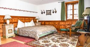 a bedroom with a bed and a desk and a television at Villa Salis in Altaussee