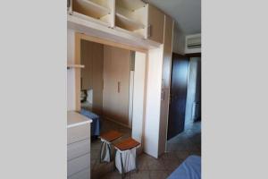 a room with a closet with a table and a stool at Appartamento sulla Laguna in Orbetello