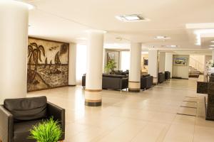 a lobby of a hospital with couches and columns at Hamburgo Palace Hotel in Balneário Camboriú