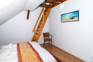 A bed or beds in a room at Sunshine Pension