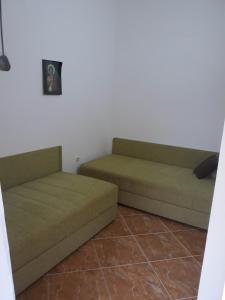 two green couches sitting in a room at Apartments Jovanic with 2 bedrooms in Sutomore