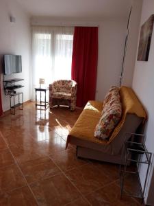 a living room with a couch and a chair at Apartments Jovanic with 2 bedrooms in Sutomore