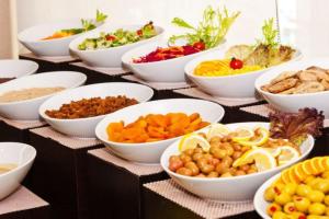 a table with bowls of vegetables and other foods at Hira Hotel in Istanbul
