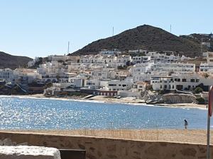 a group of white houses on a hill with a body of water at CASA BLANCA Apartments SAN JOSE in San José +23 photos