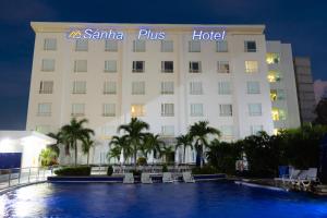 a hotel with a swimming pool in front of it at Sanha Plus Hotel in Santa Marta