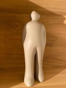 a white statue sitting on a wooden floor at The wise house in Hastière-par-delà