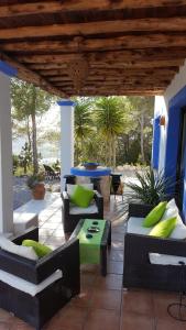 a patio with couches and a table on a patio at Sa Bardella in Sant Joan de Labritja