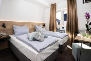 Llit o llits en una habitació de Drexel`s Parkhotel am Schloss
