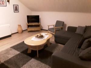 a living room with a couch and a coffee table at Apartment Schoenblick in Winterberg
