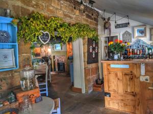 a restaurant with a counter and a table in a room at Park House in Ingleby Arncliffe