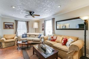a living room with two couches and a ceiling fan at 2 miles to Downtown EaDo House Jr in Houston