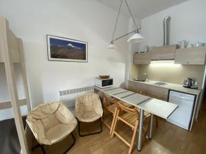 a kitchen with a table and chairs in a room at Bright Studio in "New Gudauri" in Gudauri