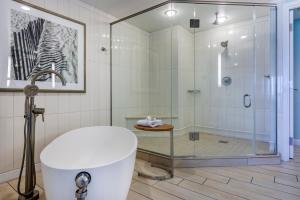a bathroom with a shower and a white tub at Omni Amelia Island Resort in Amelia Island