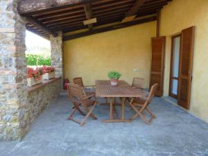 un tavolo e sedie in legno su un patio di Agrisantanna a Massa Marittima