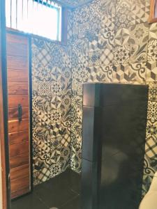 a bathroom with a toilet and a wall mounted wall mounted wall mounted wall mounted at Hotel Gallo de Mar in Puerto Escondido