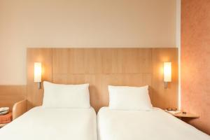 Postel nebo postele na pokoji v ubytování ibis Mulhouse Centre Filature