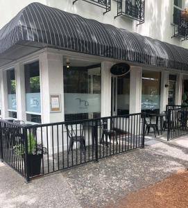 a restaurant with a black fence in front of a building at Camas Boutique Hotel in Camas