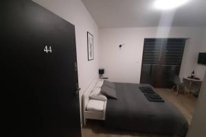 a bedroom with a large bed and a chair at Studio Fibra Barista in Rybnik