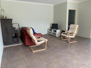 a living room with two chairs and a couch at Views on Spencer in Albany