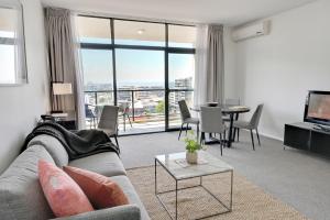 a living room with a couch and a table at Mantra Wollongong in Wollongong
