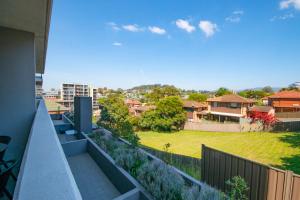 a view from the balcony of a house with a yard at Mantra Wollongong in Wollongong