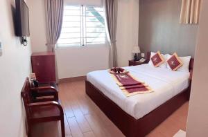 a bedroom with a large bed with a window at Golf Star Hotel in Ho Chi Minh City +48 photos