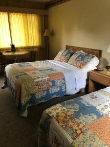 a hotel room with two beds and a table at Royal Motel in Ironwood