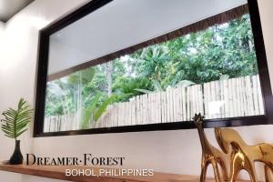 a mirror on a wall in a room with a window at Dreamer.Forest in Tangnan