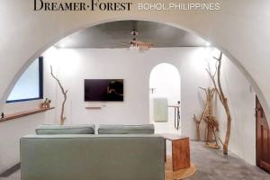 a living room with a couch and an archway at Dreamer.Forest in Tangnan