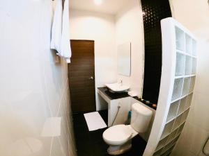 a small bathroom with a toilet and a sink at Serene Resort in Pai