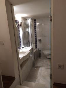 a bathroom with a sink and a shower and a toilet at Minyon Hotel in Antalya