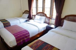 Postel nebo postele na pokoji v ubytování Punyin Hotel Inthanon -ปั้นหยิ่น โฮเทล