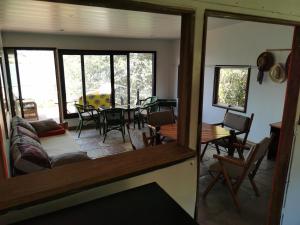a view of a living room with a table and chairs at Mama Out of Africa in Livingstone